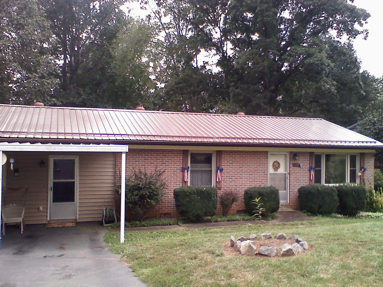 Bronze metal roof and carport on a brick ranch home — Roof Repair work by our crew in Green Valley Lake