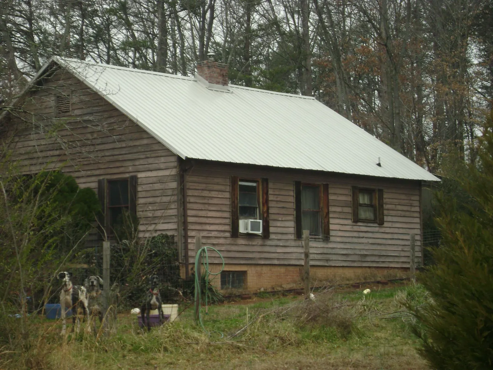 White metal roof on an old wood sided farmhouse, from a Metal Roof Installation job in Green Valley Lake